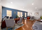 Thumbnail 3 of 42 - an office with blue walls and a wood floor and chairs