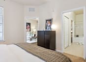 Thumbnail 15 of 42 - A bedroom with a large bed and a black cabinet.