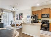 Thumbnail 5 of 42 - A modern kitchen with a black countertop and a black oven.