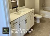 Thumbnail 17 of 47 - A bathroom with a white toilet and sink.