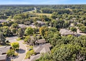 Thumbnail 12 of 16 - A bird's eye view of a residential area with houses and trees.