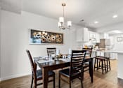 Thumbnail 5 of 15 - A dining room with a wooden table and chairs.