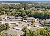 Thumbnail 14 of 15 - A bird's eye view of a residential area with houses surrounded by trees.