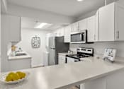 Thumbnail 3 of 16 - A kitchen with a bowl of lemons on the counter.