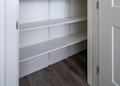 Thumbnail 8 of 16 - Empty white shelves in a white closet.
