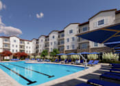 Thumbnail 1 of 3 - A large swimming pool is surrounded by sun loungers and apartment buildings.