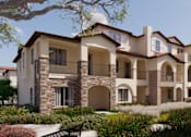 Thumbnail 2 of 3 - A large, multi-story residential building with balconies and arched windows.