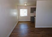 Thumbnail 1 of 20 - A room with wooden floors and a window.