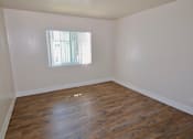 Thumbnail 12 of 20 - A room with wooden flooring and a window letting in light.