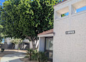 Thumbnail 3 of 20 - A white building with a sign that says "OFFICE" on the side.