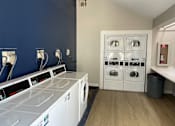 Thumbnail 14 of 20 - A laundry room with a washer and dryer.