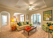 Thumbnail 14 of 51 - A living room with a couch, a coffee table, and a ceiling fan.