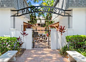 Thumbnail 20 of 30 - a wrought iron gate with a logo on it and two benches in front of it