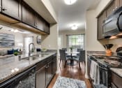 Thumbnail 7 of 35 - Mount Vernon Apartments | Desoto TX | Modern Kitchen with Shaker Style Expresso Cabinets