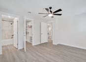 Thumbnail 17 of 22 - a bedroom with white walls and a ceiling fan