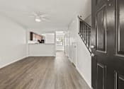 Thumbnail 1 of 16 - A long hallway with wood floors and a ceiling fan.