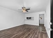 Thumbnail 19 of 32 - a living room with hardwood floors and a ceiling fan