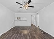 Thumbnail 18 of 32 - a living room with hardwood floors and white walls