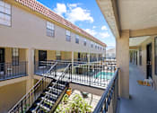 Thumbnail 14 of 16 - A balcony with a metal railing and a chair is visible.