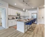 Thumbnail 1 of 60 - Kitchen with an island featuring blue bar stools in St. Johns, FL