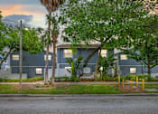Thumbnail 5 of 16 - A building with a sign that says "The Woodlands" in front of it.