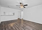 Thumbnail 14 of 32 - a bedroom with hardwood floors and a ceiling fan