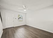 Thumbnail 8 of 16 - A room with a white door and a window with a white frame.
