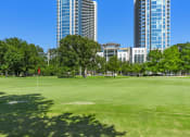 Thumbnail 19 of 114 - City park with lush greenery and modern skyscrapers in the distance in Houston, TX