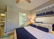 Thumbnail 38 of 56 - A bedroom with a large bed and a ceiling fan.