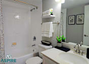 Thumbnail 27 of 56 - A white toilet with a white towel hanging on a towel rack.