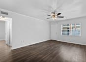 Thumbnail 16 of 32 - a bedroom with hardwood floors and a ceiling fan