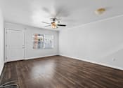 Thumbnail 17 of 32 - a bedroom with hardwood floors and a ceiling fan