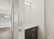 Thumbnail 13 of 16 - A bathroom with a sink and a mirror.