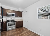 Thumbnail 10 of 32 - a kitchen with wood floors and white walls