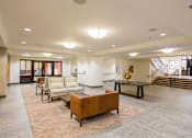 Thumbnail 4 of 28 - A spacious living room with a brown sofa and a coffee table.
