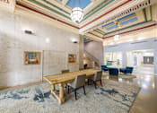 Thumbnail 4 of 36 - A large room with a wooden table and chairs.
