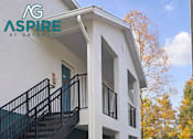 Thumbnail 21 of 56 - A white building with a blue logo on the side that says "NG ASPIRE".