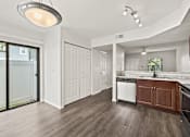 Thumbnail 9 of 16 - A modern kitchen with a white ceiling and wooden floors.