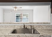 Thumbnail 8 of 32 - a kitchen with granite countertops and a sink