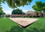 Thumbnail 45 of 47 - the yard has a volleyball court and a playground in front of a house