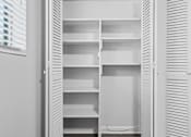 Thumbnail 12 of 32 - an empty closet with white shutters