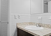 Thumbnail 21 of 32 - a bathroom with a sink and mirror