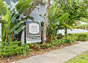 Thumbnail 3 of 16 - A sign for Fox Villa Townhomes in BC Tampa is displayed in front of a house.