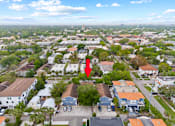 Thumbnail 16 of 16 - A red arrow points to a building in a residential area.