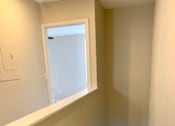Thumbnail 7 of 16 - a hallway with a staircase and a window