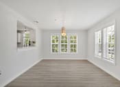 Thumbnail 13 of 22 - a living room with white walls and a large window