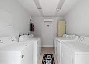 Thumbnail 32 of 32 - a room filled with white washers and dryers