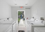Thumbnail 31 of 32 - a laundry room with white washers and dryers