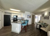 Thumbnail 5 of 46 - a view of a kitchen and a living room with a table and chairs