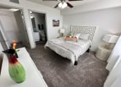 Thumbnail 8 of 46 - a bedroom with a bed and a vase on the floor